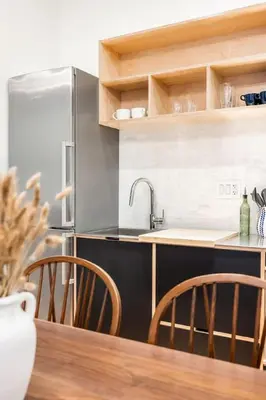 a kitchen with a stainless steel refrigerator and a wooden table at Walk to ALL - Washington Park - FREE Streetcar in Cincinnati