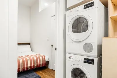 a white laundry room with a washer and dryer at Walk to ALL - Washington Park - FREE Streetcar in Cincinnati