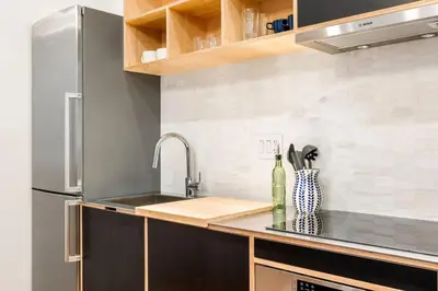 a kitchen with a sink and a refrigerator at Walk to ALL - Washington Park - FREE Streetcar in Cincinnati