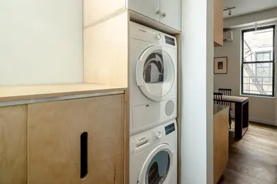a kitchen with a washer and dryer in a room at Walk to ALL - Washington Park - Gorgeous 2BR Condo in Cincinnati