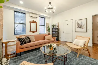 a living room with a couch and a table at Walk to ALL - Washington Park - Gorgeous 2BR Condo in Cincinnati