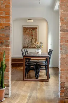 a dining room with a wooden table and chairs at Walk to ALL - Washington Park - Gorgeous 2BR Condo in Cincinnati