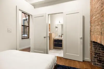 a bedroom with a bed and a brick wall at Walk to ALL - Washington Park - FREE Streetcar in Cincinnati