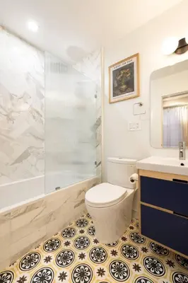 a bathroom with a toilet and a shower and a sink at Walk to ALL - Washington Park - Gorgeous 2BR Condo in Cincinnati