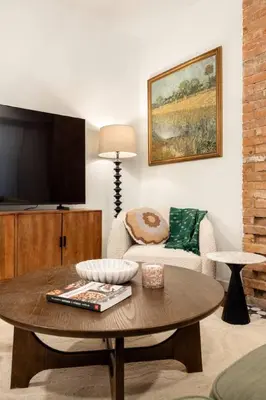 a living room with a coffee table and a tv at Walk to ALL - Washington Park - Gorgeous 2BR Condo in Cincinnati
