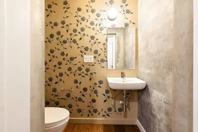 a bathroom with a white toilet and a sink at Walk to ALL - Washington Park - Gorgeous 2BR Condo in Cincinnati
