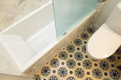 a bathroom with a toilet and a tile floor at Walk to ALL - Washington Park - Gorgeous 2BR Condo in Cincinnati