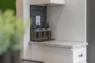 a shelf with bottles of alcohol on a wall at Hot Tub - Game Room - Chic & Spacious - Sleeps 10 in Cleveland