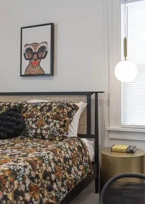 a bedroom with a bed and a picture of an owl at Hot Tub - Game Room - Chic & Spacious - Sleeps 10 in Cleveland