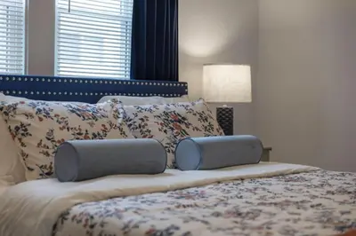 a bedroom with a large bed with pillows at Hot Tub - Game Room - Chic & Spacious - Sleeps 10 in Cleveland