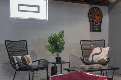 a patio with two chairs and a table with pillows at Hot Tub - Game Room - Chic & Spacious - Sleeps 10 in Cleveland