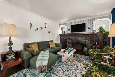 a living room with a couch and a fireplace at Hot Tub - Game Room - Chic & Spacious - Sleeps 10 in Cleveland