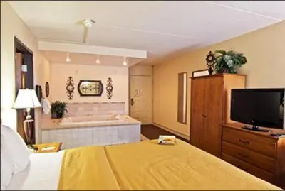 a hotel room with a bed and a television at Quality Inn Chillicothe in Chillicothe