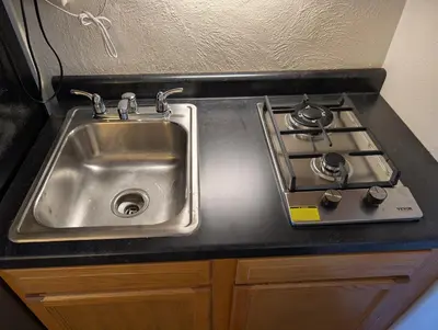 a kitchen sink with a stove next to it at Terry Point Motel in Richfield