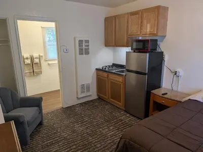a small kitchen with a refrigerator and a stove at Terry Point Motel in Richfield