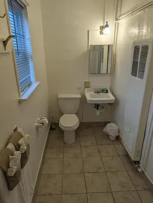 a bathroom with a toilet and a sink at Terry Point Motel in Richfield