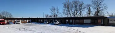 a building with cars parked outside in the snow at Terry Point Motel in Richfield