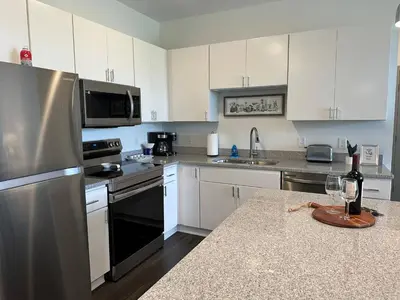 a kitchen with white cabinets and stainless steel appliances at The Dublin Designer 1st Floor Available Now in Dublin