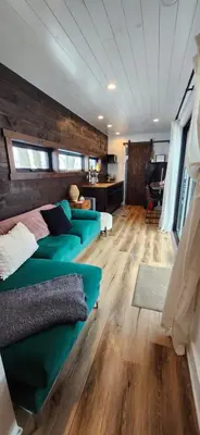 a living room with two green couches in a room at Wildwood Retreat in Dalton