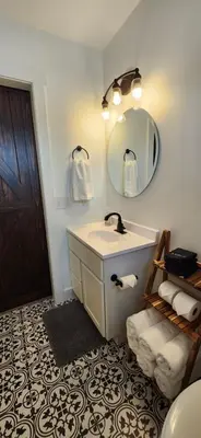 a bathroom with a sink and a mirror at Wildwood Retreat in Dalton