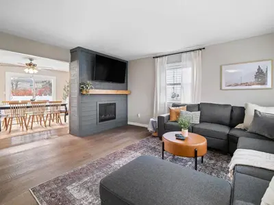 a living room with a couch and a fireplace at Vermilion Retreat with Game Room, Hot Tub and Across from Community Pool in Vermilion