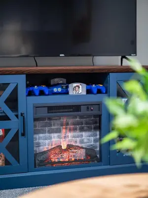 a fireplace with a tv on top of it at Vermilion Retreat with Game Room, Hot Tub and Across from Community Pool in Vermilion