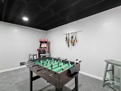 a foosball table in a room with a game at Vermilion Retreat with Game Room, Hot Tub and Across from Community Pool in Vermilion