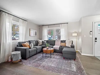 a living room with a couch and a table at Vermilion Retreat with Game Room, Hot Tub and Across from Community Pool in Vermilion