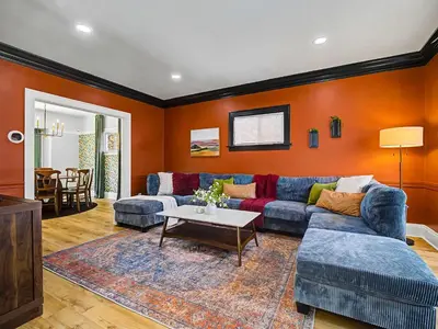 a living room with a couch and a table at 4 Bed 2 Bath Walk to Lakewood Restaurants and Shops in Lakewood