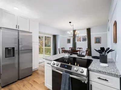 a kitchen with a stainless steel refrigerator and a stove at 4 Bed 2 Bath Walk to Lakewood Restaurants and Shops in Lakewood