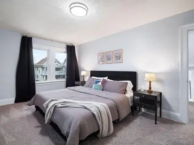a bedroom with a large bed and a window at 4 Bed 2 Bath Walk to Lakewood Restaurants and Shops in Lakewood