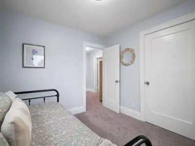 a bedroom with a bed and a mirror on the wall at 4 Bed 2 Bath Walk to Lakewood Restaurants and Shops in Lakewood