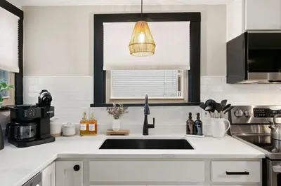 a kitchen counter with a sink and a window at Modernized Historical Home in Downtown Medina with Hot Tub in Medina
