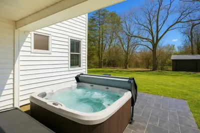 a hot tub on the side of a house at Modernized Historical Home in Downtown Medina with Hot Tub in Medina