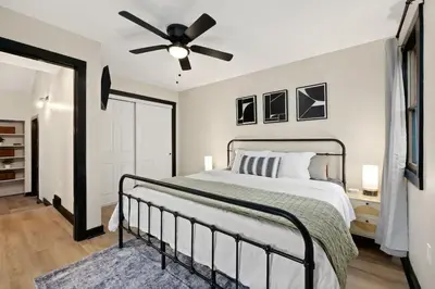 a bedroom with a bed and a ceiling fan at Modernized Historical Home in Downtown Medina with Hot Tub in Medina