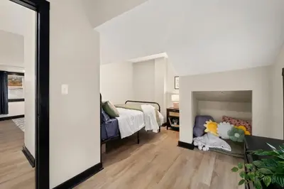 a bedroom with a bed and a mirror at Modernized Historical Home in Downtown Medina with Hot Tub in Medina