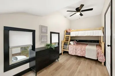 a bedroom with a bed and a ceiling fan at Modernized Historical Home in Downtown Medina with Hot Tub in Medina
