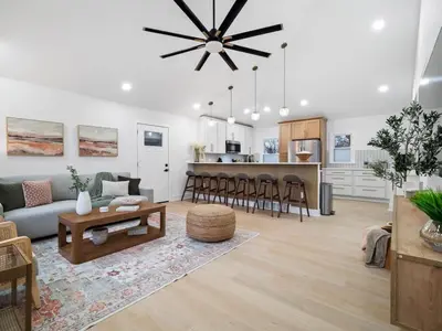 a living room and kitchen with a couch and a table at Luxurious Retreat with Sauna and Modern Design in Warrensville Heights