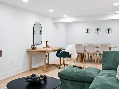 a living room with a couch and a table and chairs at Luxurious Retreat with Sauna and Modern Design in Warrensville Heights