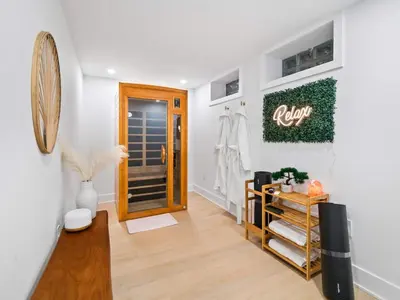 a room with a hallway with a door and a mirror at Luxurious Retreat with Sauna and Modern Design in Warrensville Heights