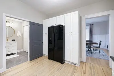 a kitchen with a black refrigerator in a room at Walk to Highland Square, Sleeps 8 in Akron