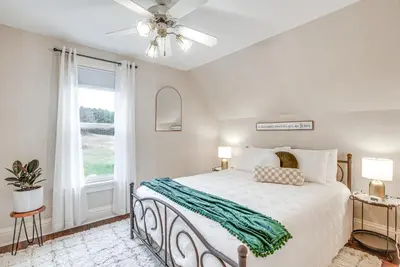 a bedroom with a bed and a ceiling fan at Patio and Scenic Views Modern Ohio Farmhouse in Bellville