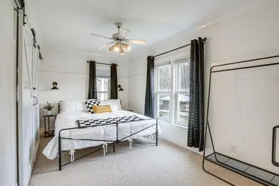 a bedroom with a bed and a projection screen at Patio and Scenic Views Modern Ohio Farmhouse in Bellville