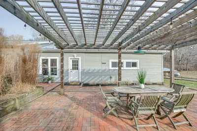 a patio with a wooden pergola with a table and chairs at Patio and Scenic Views Modern Ohio Farmhouse in Bellville
