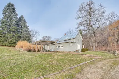 a white house with a gray roof in a yard at Patio and Scenic Views Modern Ohio Farmhouse in Bellville