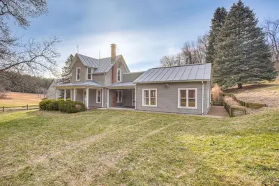a house on a hill with a yard at Patio and Scenic Views Modern Ohio Farmhouse in Bellville