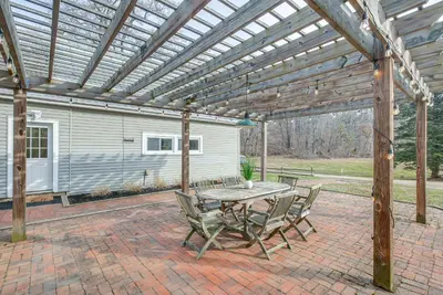 a patio with a table and chairs under a pergola at Patio and Scenic Views Modern Ohio Farmhouse in Bellville