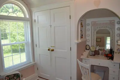 a kitchen with a white door and a vanity and a mirror at Mohican Farmhouse, Pond, and Animals in Perrysville