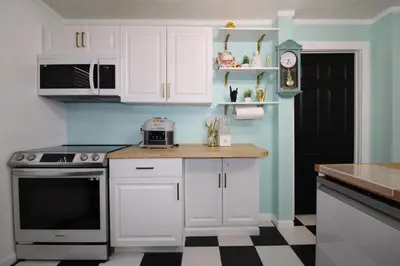 a kitchen with white cabinets and a counter top at Rock N Roll, Mins to CP & SF, King, Pet OK in Sandusky