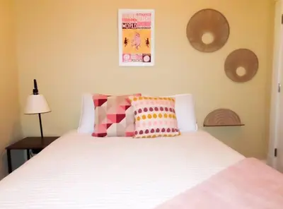 a bedroom with a white bed with pillows on it at The Nook on Neil Walkable 3BR in Columbus
